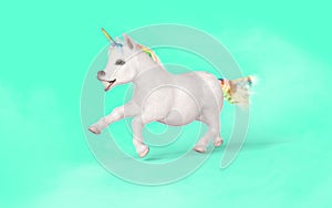 White unicorn with rainbow horn isolated on green background.