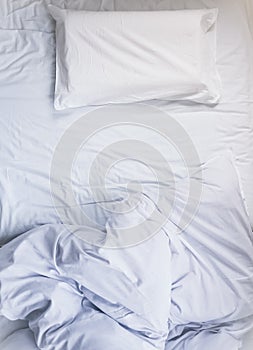 White unmade Bed mattress Duvet with pillow and blanket Top view