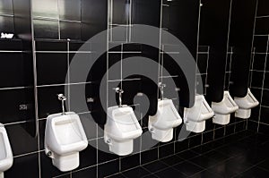 White urinals with black tiles