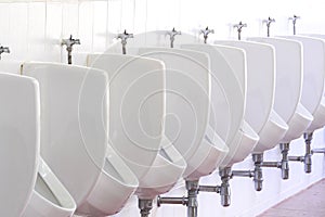 White urinals ceramic men public toilet in bathroom