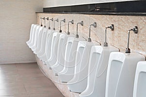 white urinals men public toilet