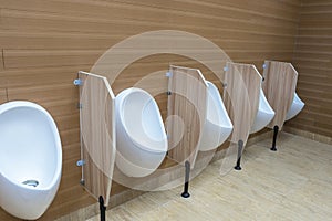 White urinals in men`s bathroom