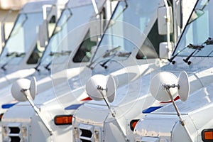 White US mail trucks in a row