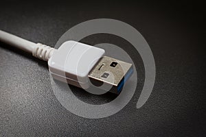 White usb 3.0 cable with micro B connector on background