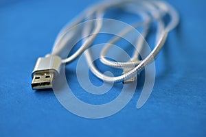 White USB cable on a blue background