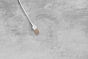 White USB cable on concrete background