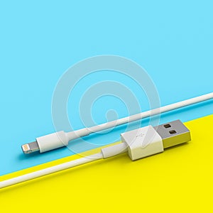 White usb cable on yellow and blue background