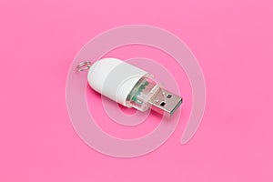 White USB flash drive on a pink background