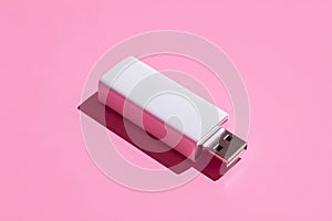 White usb flash drive on a pink background with shadow effect