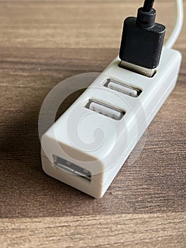 a white usb hub with a black usb cable