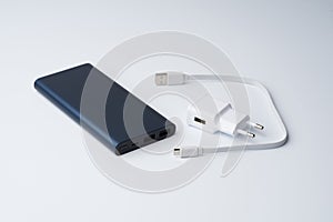 White USB power adapter, cable and blue power bank for divice isolated on a white background