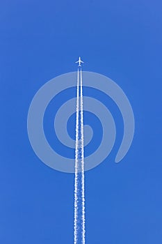 White vapor trail from the jet plane on blue sky