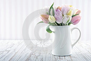 White vase with colorful tulips
