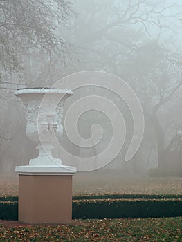 White vase sculpture in the fog in the fall. Gomel, Belarus