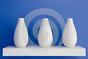 White vases on blue