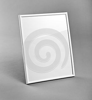 White vertical frame for paintings or photographs on gray background