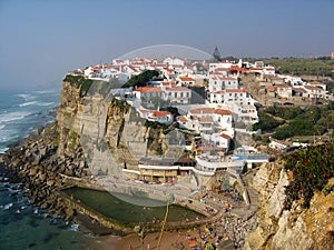 White village perched on a rock on the sea in Portugal.