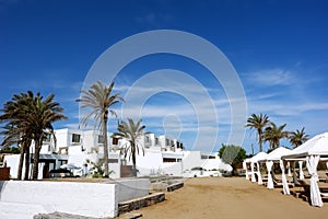 The white villas, palms and blue greece sky.