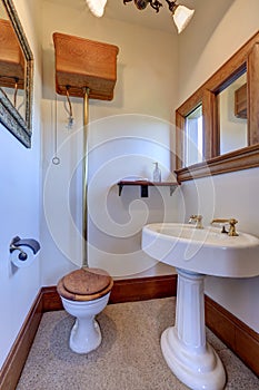 White vintage bathroom interior with brown trim.