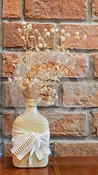 White vintage bottle with dried flower