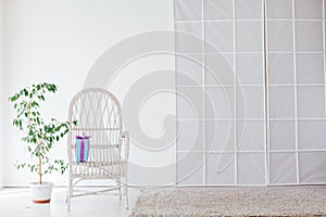 White vintage chair with a gift in the interior of an empty white room