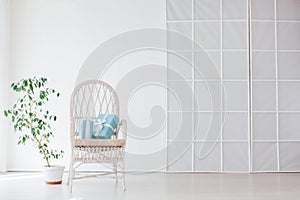 White vintage chair with gifts in the interior of a white empty room