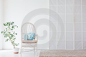 White vintage chair in the interior of an empty white room