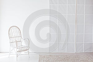 White vintage chair in the interior of an empty white room