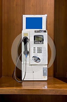 White vintage public pay phone