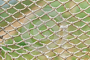 White vintage rope net texture is on green grass background