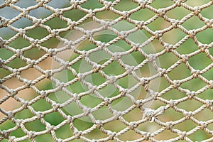 White vintage rope net texture is on green grass background