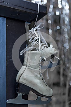 White vintage skates on a Christmas silver defocused background