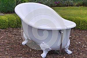 White vintage style bathtub in a garden