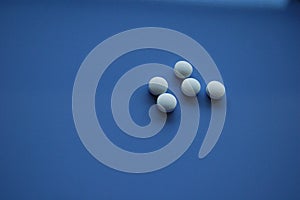 White vitamins or pills on blue background copy space
