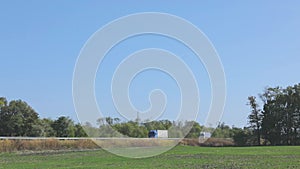 A white wagon drives along the highway in sunny weather. Truck on the highway