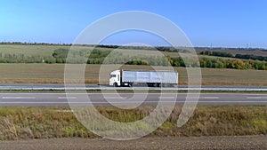 A white wagon drives along the highway in sunny weather. Truck on the highway