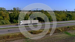 A white wagon drives along the highway in sunny weather. Truck on the highway