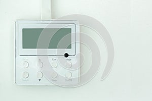 White wall air conditioning control panel.