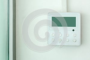 White wall air conditioning control panel.