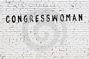 White wall with black paint inscription congresswoman on it photo