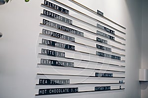 White wall of a cafe with a typesetting or hanging menu on it