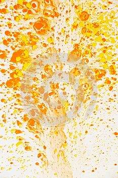 White wall with chaotic orange paint drops