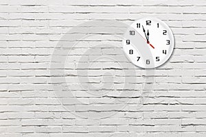 White wall clock on white brick wall background