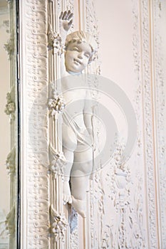 White wall with Cupid sculpture