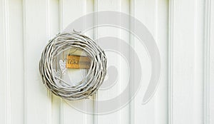 White wall with a door decoration stick wreath