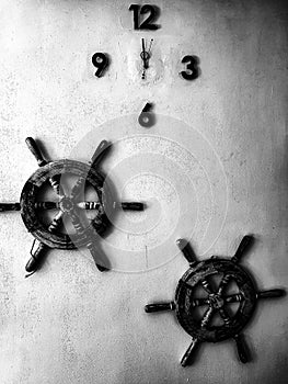 The white wall ornaments with steering wheel and clock