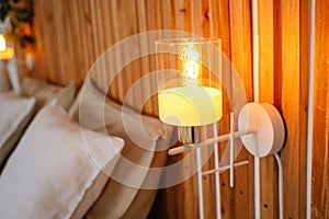 White wall sconces with yellow bulb on