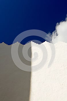 White wall with shadow and blue sky
