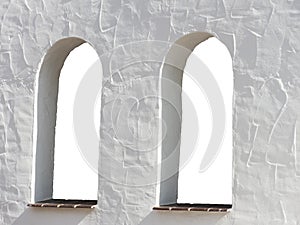 White wall with two arch windows