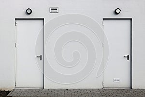 White wall with two closed doors